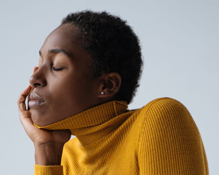 woman in a yellow turtleneck