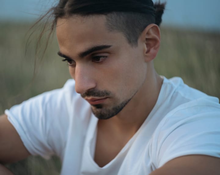 man with beard and hair pulled back