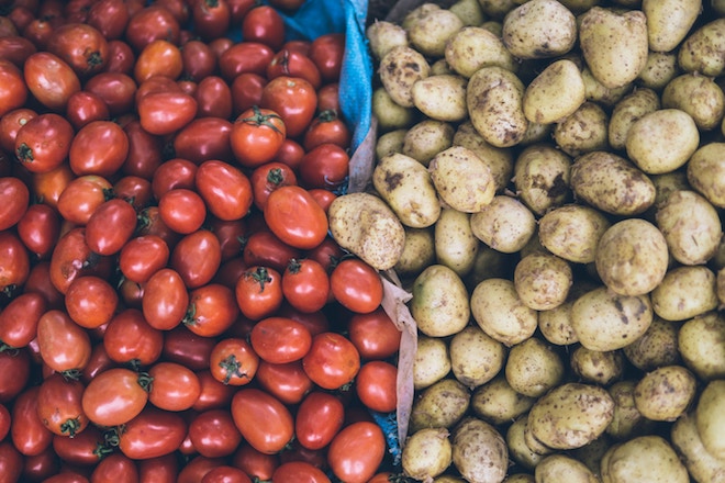 A rogue potato tries to escape into the tomato bin