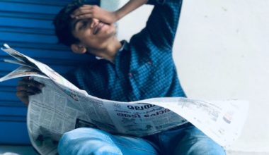 distressed man reading newspaper