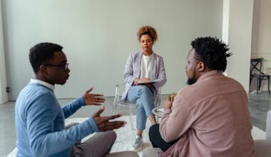 two men talking to a couples counselor