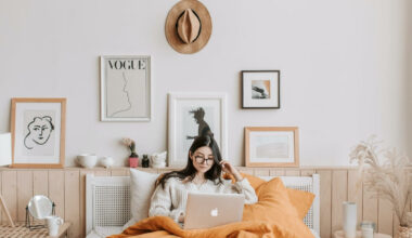 woman lying in bed on computer