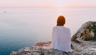 woman sitting near the ocean