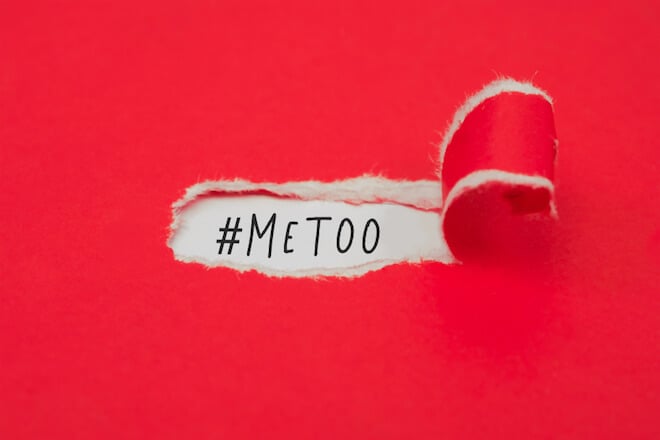 A torn red piece of paper exposes the words "#MeToo"