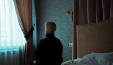 Woman sitting alone on bed