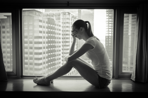 anxious woman in windowsill