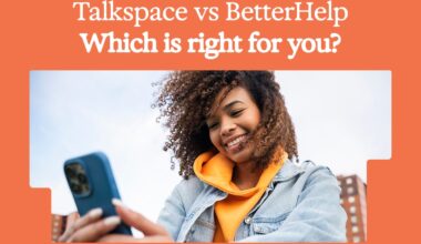 smiling woman looking at her phone with an orange background