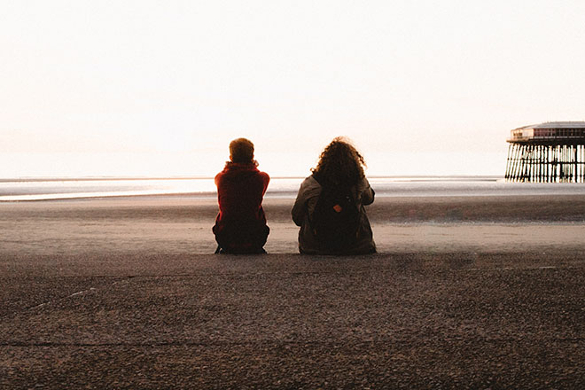 Two people sitting next to each other